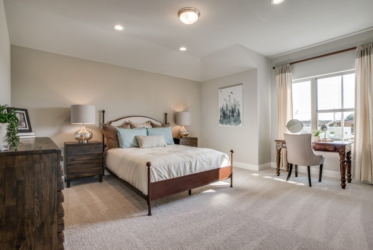Large white master bedroom in Heritage Creekside home by Cambridge Homes