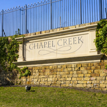 Sign on front gate for Chapel Creek community in Frisco, Texas