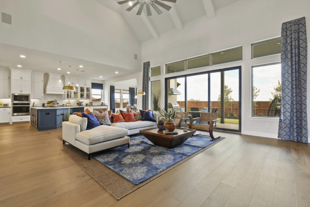 Interior of spacious open floor plan living room in a model home by Cambridge Homes in the Prairie View community in Frisco, Texas